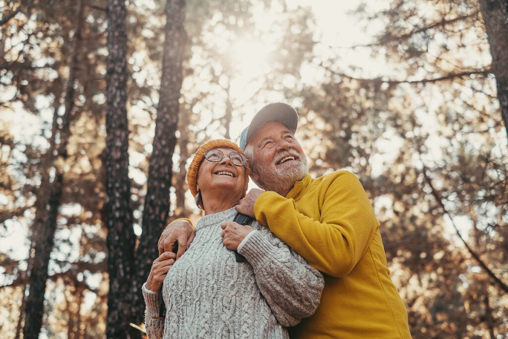 middle age cheerful people smiling and looking at the the trees