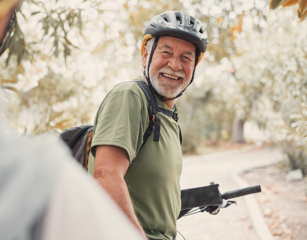 older man enjoying riding bikes scaled
