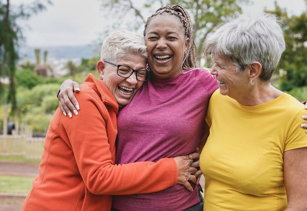 older women laughing and holding eachother