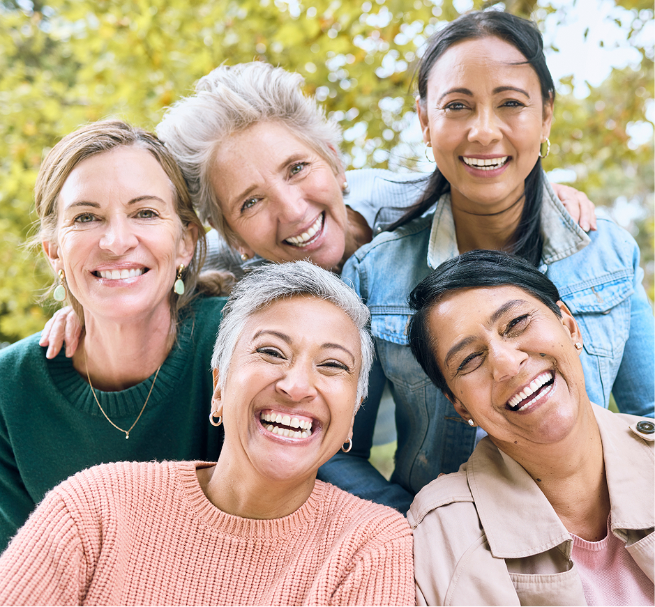 women smiling for picture together mobile