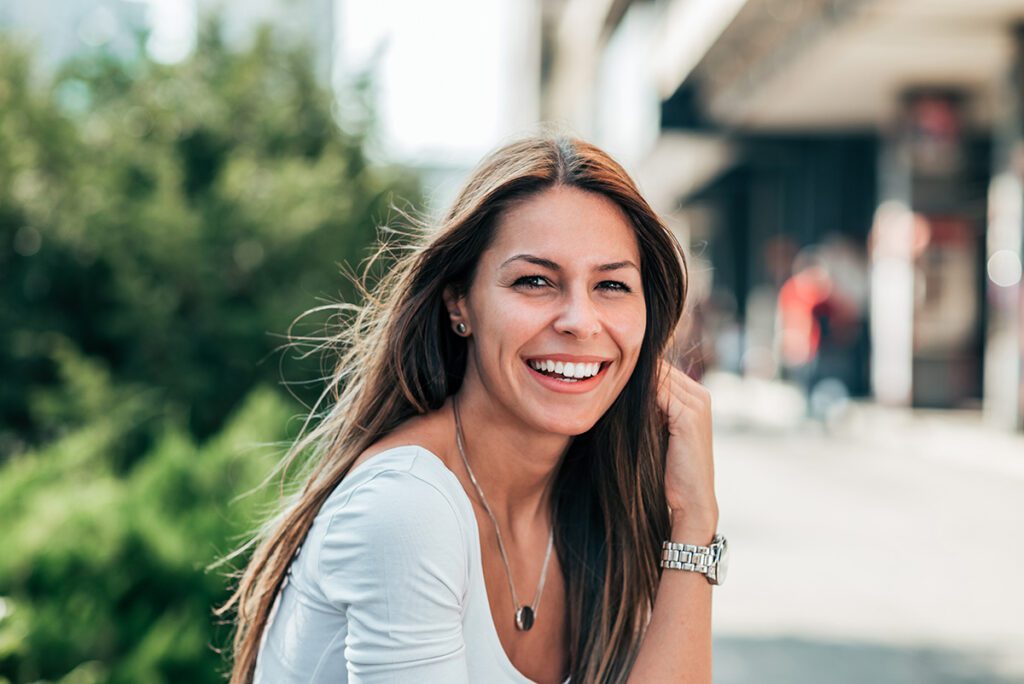 women smiling for portrait outdoors