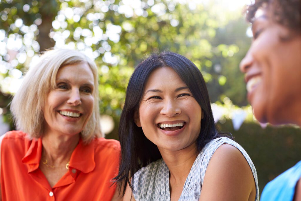 women smiling talking with friends