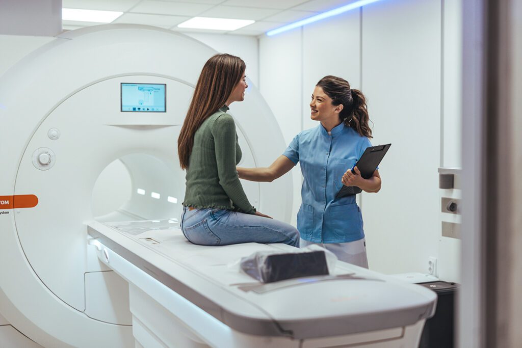 Healthcare Technician Assisting Woman During CT