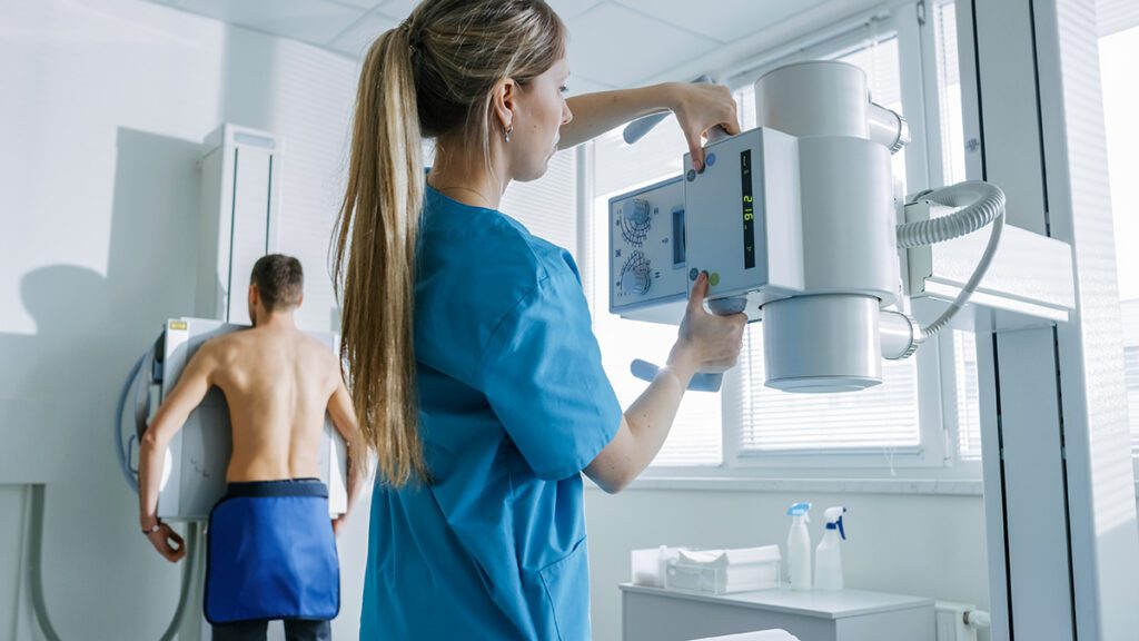 Medical Technician Adjusts X Ray Machine mobile