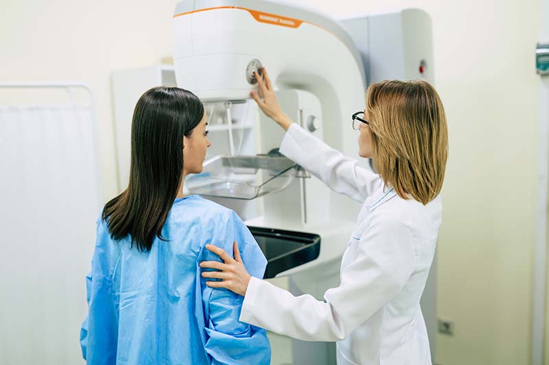 radiologist with patient during a mammogram screening