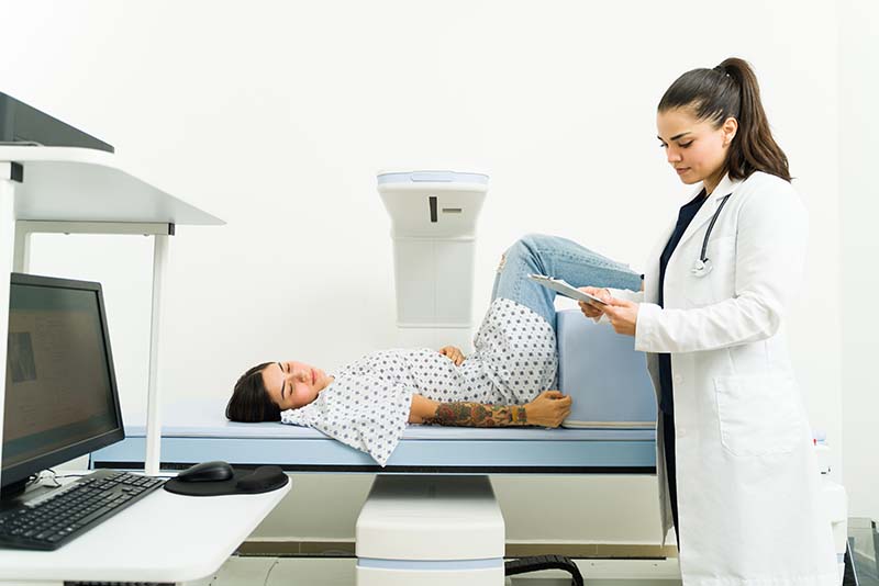 Sick female patient waiting for the densitometry test results at the lab mobile